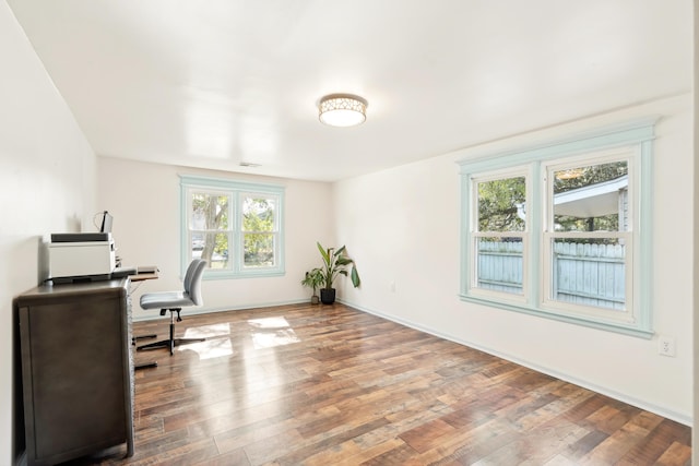 home office with visible vents, baseboards, and wood finished floors