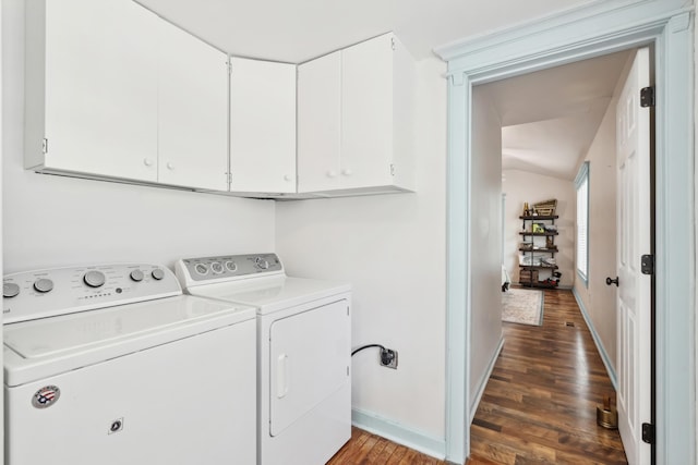 laundry room featuring cabinet space, baseboards, dark wood-type flooring, and washing machine and clothes dryer