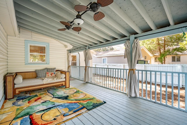 deck featuring ceiling fan and fence