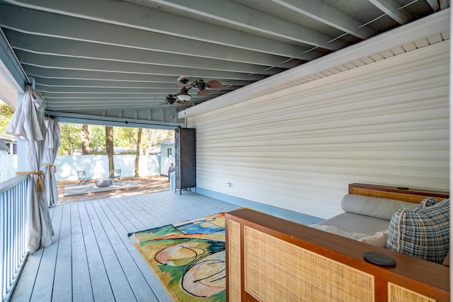 wooden terrace featuring a ceiling fan and fence