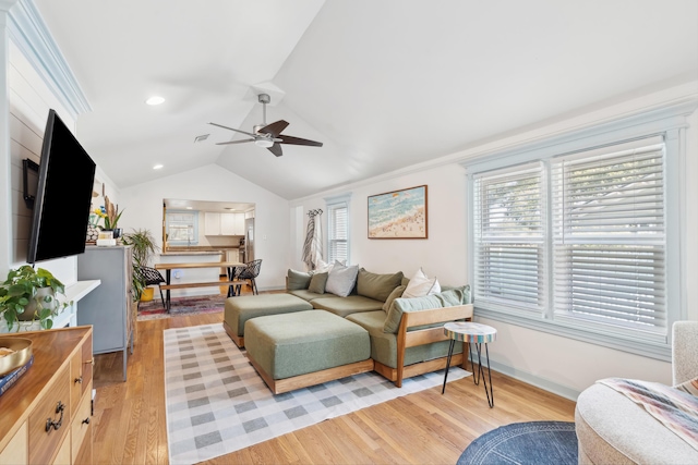 living room featuring light wood finished floors, baseboards, a ceiling fan, lofted ceiling, and recessed lighting