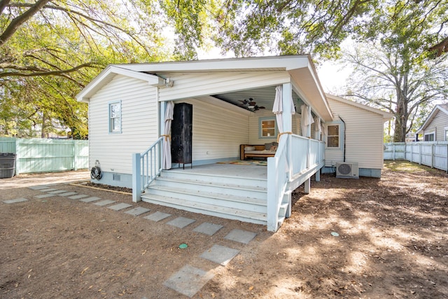 exterior space with crawl space, ac unit, fence, and a ceiling fan