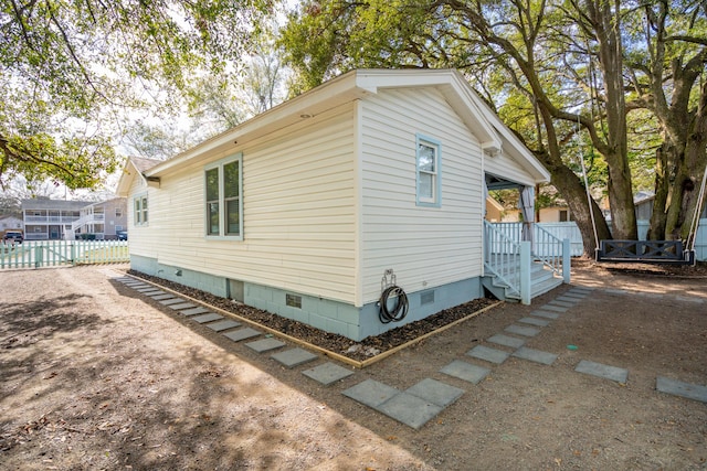 view of property exterior featuring crawl space and fence