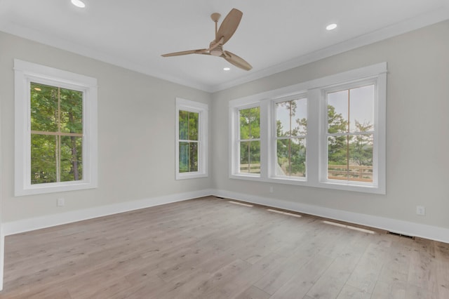 unfurnished room featuring ceiling fan, crown molding, and light hardwood / wood-style flooring