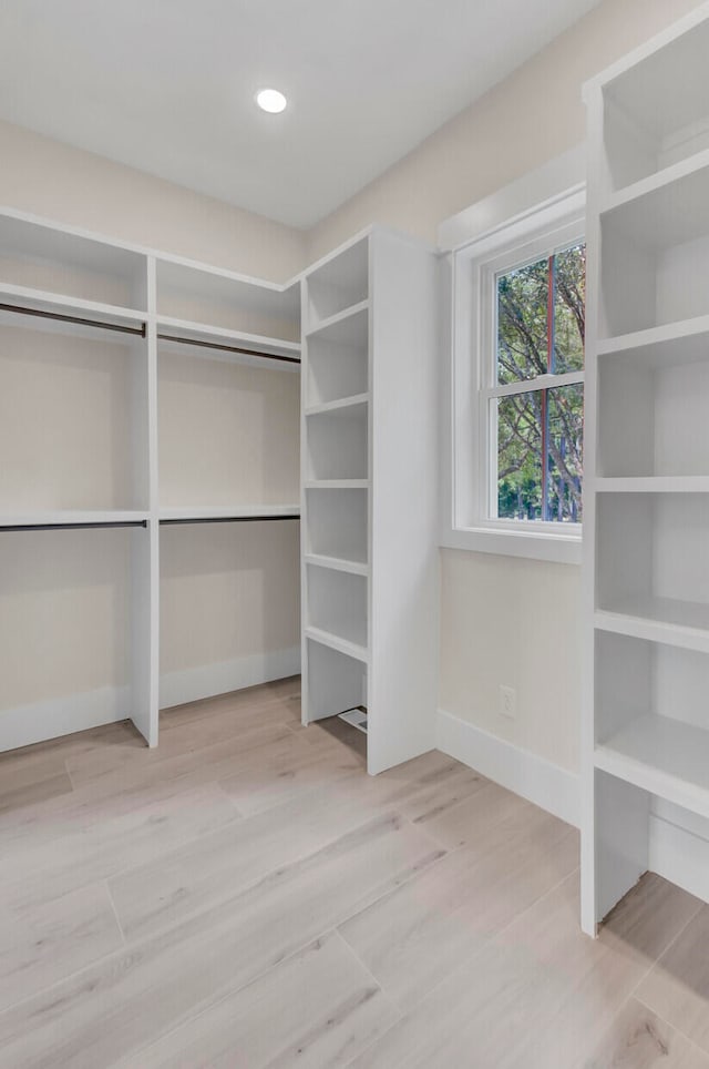 spacious closet with light hardwood / wood-style floors