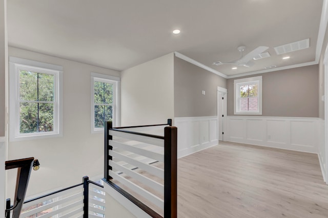 interior space with light hardwood / wood-style floors and ornamental molding