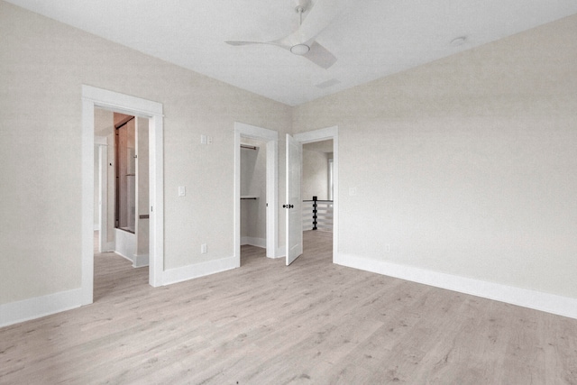 unfurnished bedroom featuring ceiling fan, a closet, and light wood-type flooring