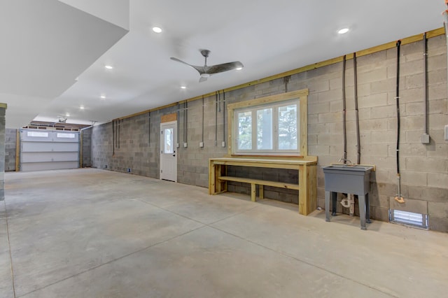 garage with a workshop area and ceiling fan