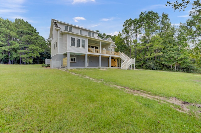 rear view of house with a yard and ceiling fan