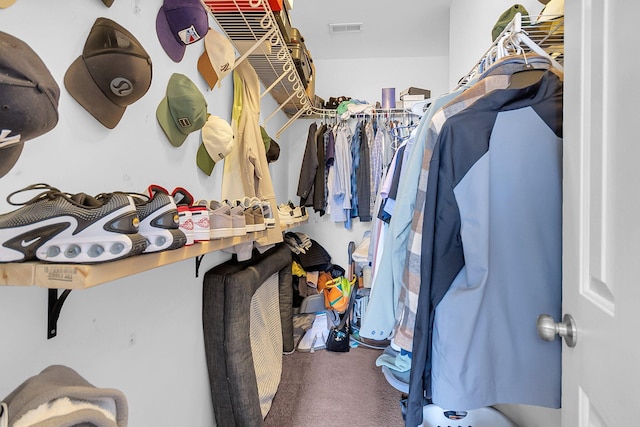 walk in closet with visible vents and carpet flooring