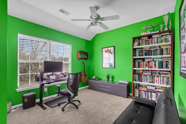 office area with visible vents, a healthy amount of sunlight, lofted ceiling, and carpet