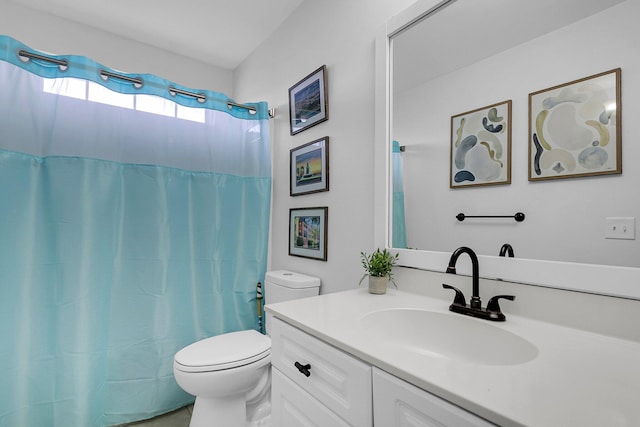 bathroom with toilet, vanity, and a shower with curtain