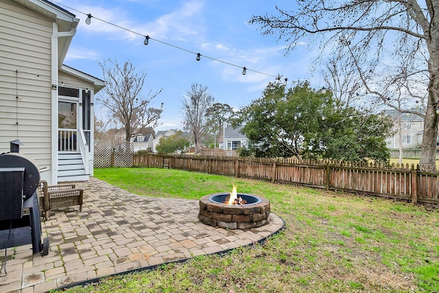 view of yard with an outdoor fire pit, a fenced backyard, and a patio area