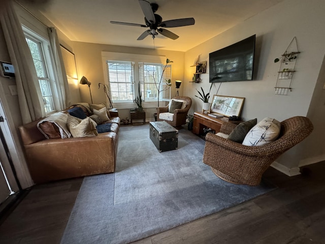 living room featuring ceiling fan and dark hardwood / wood-style flooring