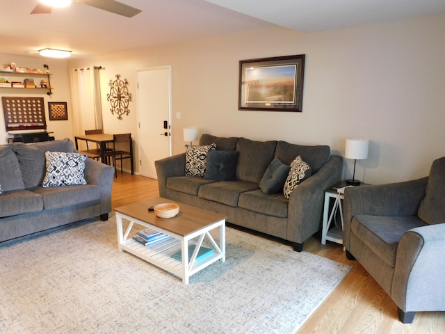 living room with wood-type flooring and ceiling fan