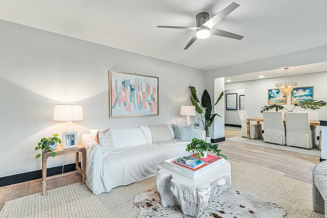 living room featuring ceiling fan and hardwood / wood-style flooring