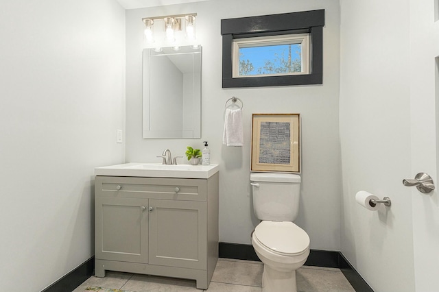 bathroom featuring tile patterned floors, vanity, and toilet