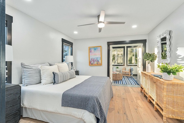 bedroom featuring multiple windows, ceiling fan, and hardwood / wood-style flooring