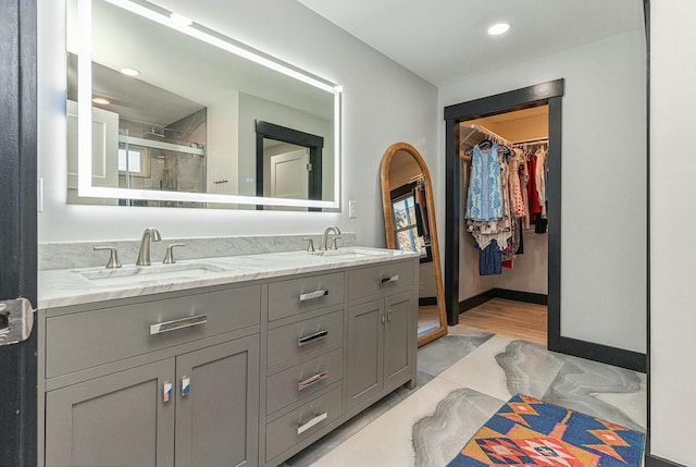 bathroom with an enclosed shower and vanity