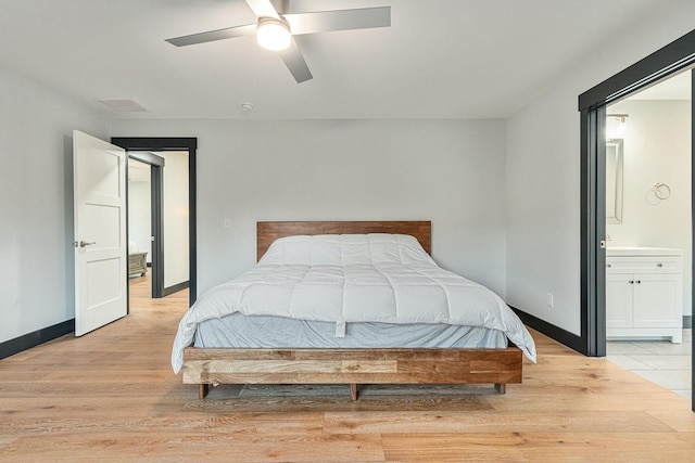 bedroom with connected bathroom, ceiling fan, and light hardwood / wood-style flooring