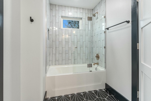 bathroom featuring tile patterned floors and tiled shower / bath