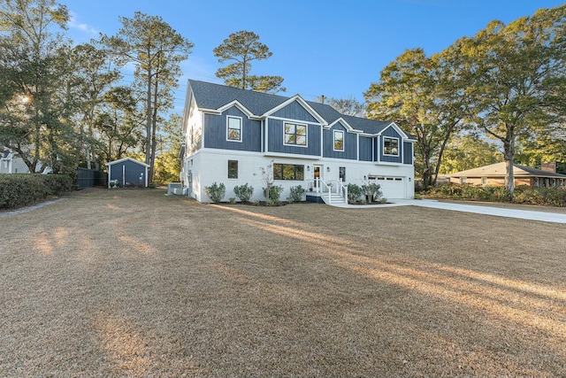 view of front of home with a storage shed and a garage