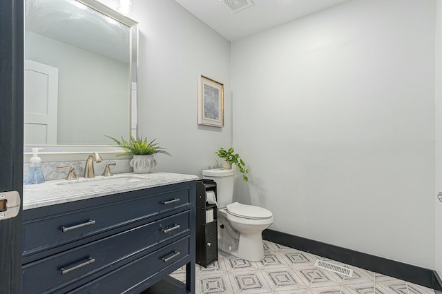 bathroom with toilet and vanity