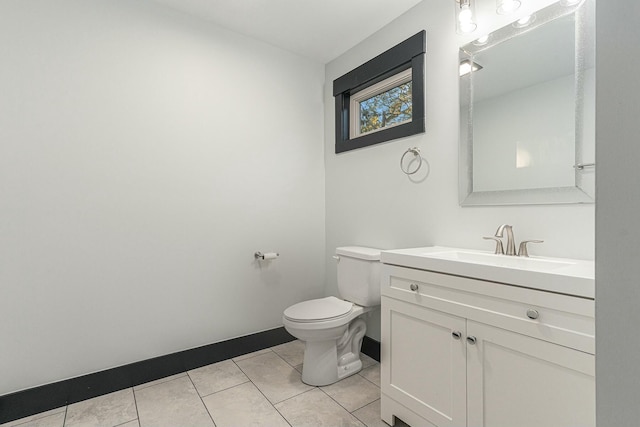 bathroom featuring vanity, tile patterned floors, and toilet