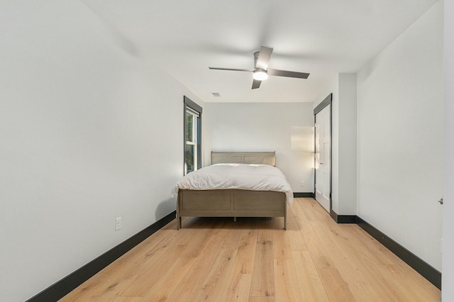 bedroom with ceiling fan and light hardwood / wood-style flooring