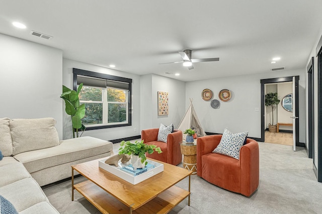 living room featuring light colored carpet and ceiling fan