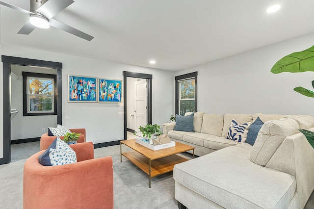 living room with ceiling fan and light colored carpet