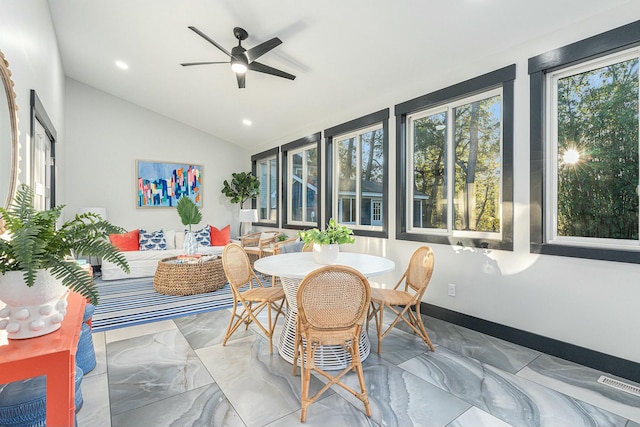 sunroom / solarium with lofted ceiling and ceiling fan