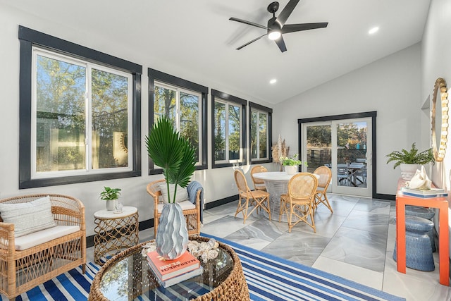 sunroom / solarium with ceiling fan, a healthy amount of sunlight, and lofted ceiling