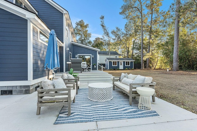 view of patio / terrace with a wooden deck, an outdoor structure, and outdoor lounge area