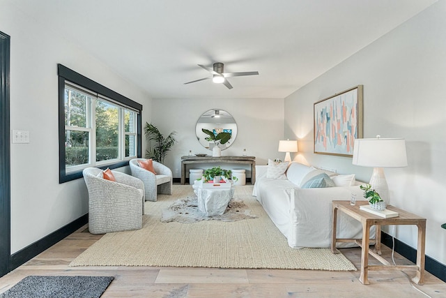 living room with ceiling fan and light hardwood / wood-style floors