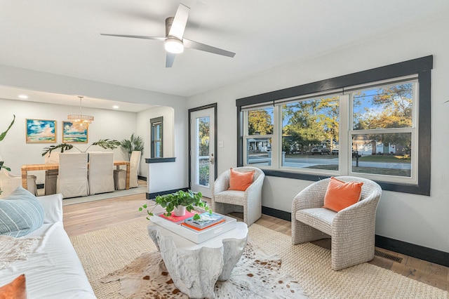 living room with ceiling fan and light hardwood / wood-style floors