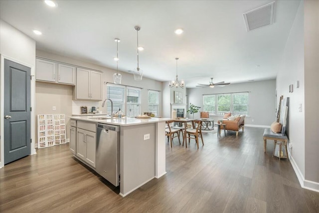 221 Lucca Dr, Summerville, SC 29486 - kitchen with stainless steel dishwasher, a sink, open floor plan, light countertops, and visible vents
