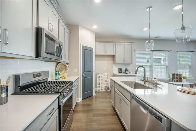 221 Lucca Dr, Summerville, SC 29486 - kitchen featuring dark wood finished floors, light countertops, a sink, tasteful backsplash, and appliances with stainless steel finishes