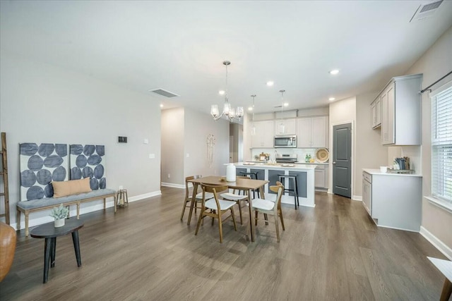 221 Lucca Dr, Summerville, SC 29486 - dining space with baseboards, dark wood-style flooring, a chandelier, and visible vents