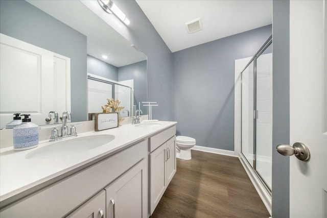 221 Lucca Dr, Summerville, SC 29486 - bathroom featuring a sink, double vanity, a stall shower, visible vents, and wood finished floors