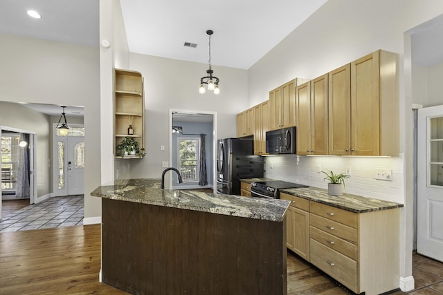 kitchen featuring visible vents, open shelves, dark stone counters, appliances with stainless steel finishes, and tasteful backsplash