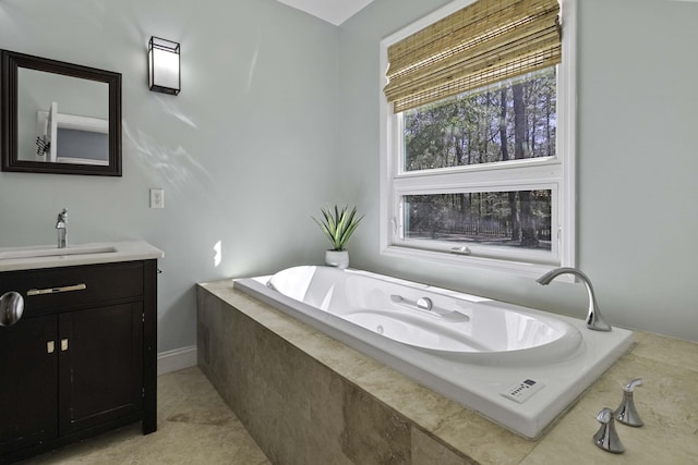 full bathroom featuring vanity, tile patterned floors, and a jetted tub