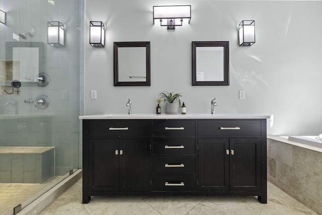 bathroom featuring a sink, tiled shower, double vanity, and tile patterned flooring