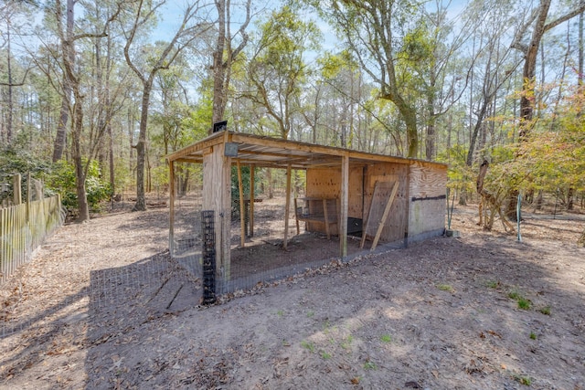 view of poultry coop featuring fence