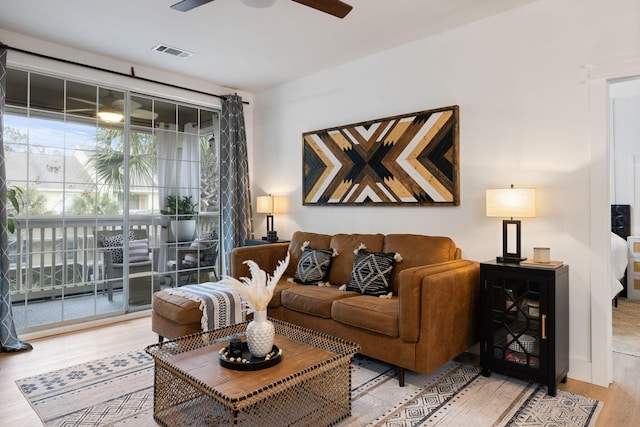 living room featuring ceiling fan and hardwood / wood-style floors