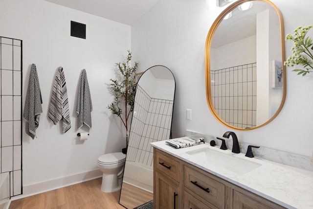 bathroom featuring hardwood / wood-style flooring, vanity, and toilet