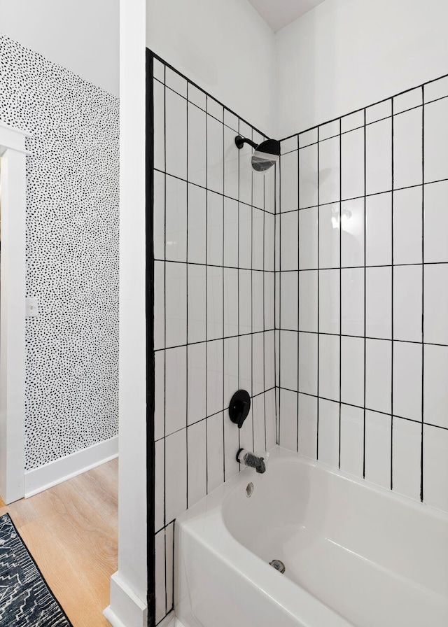 bathroom featuring tiled shower / bath and hardwood / wood-style flooring