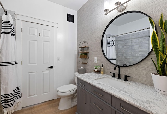 bathroom with hardwood / wood-style floors, vanity, and toilet