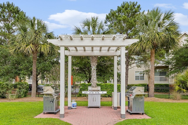 view of property's community featuring a pergola and a lawn