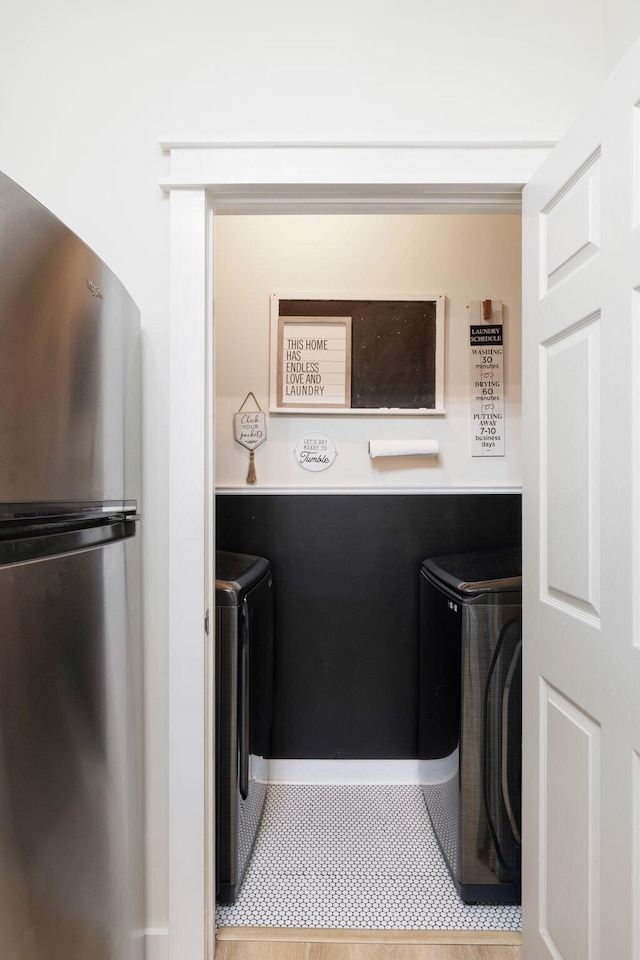 clothes washing area featuring separate washer and dryer